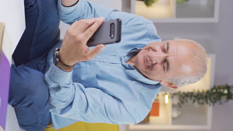 Vertical-video-of-Old-man-in-love-video-call-on-the-phone.